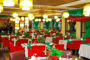jadalnia z czerwonymi krzesłami i stołami z dekoracjami świątecznymi w obiekcie IBOM ICON HOTEL AND GOLF RESORT w mieście Mbiakong