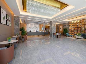 a lobby of a hotel with a chandelier at Campanile Hotel Shenzhen Guanlan Goft in Tiantangwei