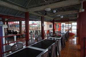 a room with a row of tables and chairs at Sunset Curly Bay Hotel & Resort in Tanjung Pinang 