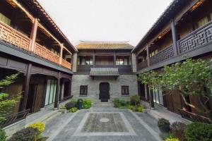 an external view of a building with a courtyard at Blossom House Xuzhou Huilongwo Banyunting in Xuzhou