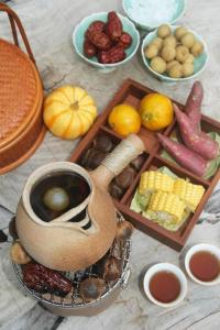 a table topped with different types of food and drinks at Blossom House Xuzhou Huilongwo Banyunting in Xuzhou
