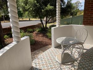 a table and a chair on a patio at Herbert Cottage in Tumut
