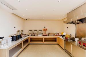 eine große Küche mit einer Theke mit vielen Geräten in der Unterkunft City Comfort Inn Fengcheng Recycle Park Geliyang 