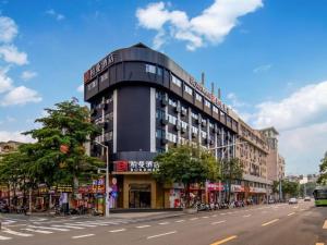 a building on the side of a city street at Borrman Hotel Zhongshan Lihe Plaza in Zhongshan