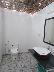 a bathroom with a sink and a toilet at INAS OCEAN FRONT in Canacona