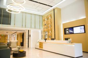 a lobby with a reception desk and a chandelier at City Comfort Inn Badong Passenger Transport Center in Badong