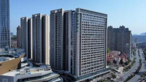 a group of tall buildings in a city at City Comfort Inn Yichang Zhongnan Road Changjiang Plaza in Baiyang