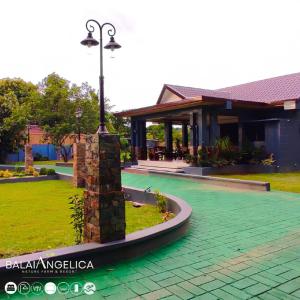 a house with a street light in front of it at Balai Angelica - Nature Farm & Resort in Pagsanjan