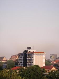 a city skyline with a tall building in the foreground at Meatophum Samnang in Battambang