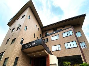 a building with a sign on the front of it at Hotel & Onsen 2307 Shiga Kogen in Shiga Kogen