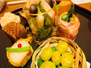 a tray filled with different types of bread and pastries at Hotel & Onsen 2307 Shiga Kogen in Shiga Kogen