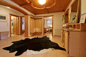 a large black rug on the floor of a room at Alpen Appartements Hochmuth in Mayrhofen