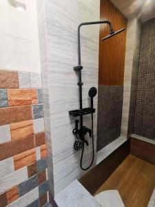 a shower in a bathroom with a wall at 7 Class Pool Villa in Chachoengsao