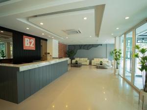 a lobby with a bar in a building at B2 Nakhon Sawan Boutique & Budget Hotel in Ban Nong Krot Nok