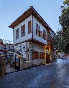 a house on a cobblestone street with a gate at Hotel 1207 Special Class in Antalya