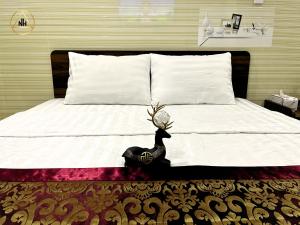 a bedroom with a bed with a turkey on it at Gia Hân Hotel Bình Tân in Ho Chi Minh City