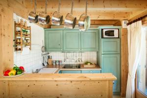 a kitchen with blue cabinets and a counter top at Chalet L'Ours Blanc - OVO Network in Le Grand-Bornand