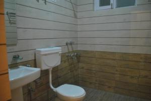 a bathroom with a toilet and a sink at Agastya Residency Dharamshala in Dharamshala