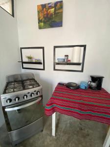 a kitchen with a stove and a table with a blanket at Casa D'Andrea in Flores