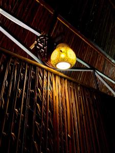 a light hanging from a ceiling in a room at Hometravel Mekong Can Tho in Can Tho