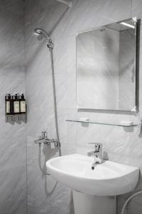 東港的住宿－宜家莊親子民宿，白色的浴室设有水槽和镜子