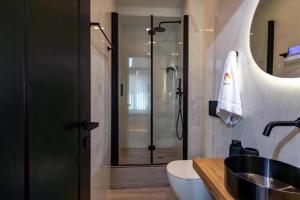 a bathroom with a shower and a sink at Triple A - Stylish Seven On The Pedestrian - FREE Parking! in Athens +18 photos