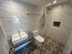 a bathroom with a toilet and a sink at The Farmhouse in Ipoh
