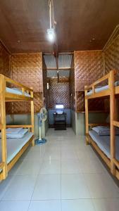 a room with three bunk beds and a desk at Sabas Beach and Campsite in Siquijor