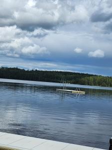 a boat sitting on the water on a lake at Ananis Stuga in Svartå