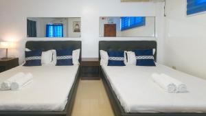 Postel nebo postele na pokoji v ubytování ADC Resort and Hotel Apalit Pampanga