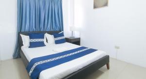 Postel nebo postele na pokoji v ubytování ADC Resort and Hotel Apalit Pampanga