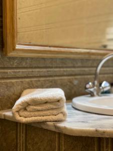 a pile of towels sitting on a counter in a bathroom at Rock City Resort in Swat