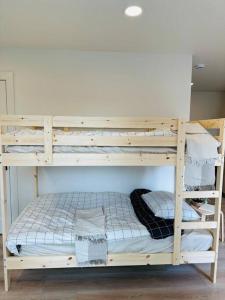 a wooden bunk bed with a pillow on it at Studio Modern luxe apartment in Vancouver