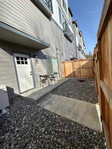 a house with a bench in front of a door at Studio Modern luxe apartment in Vancouver