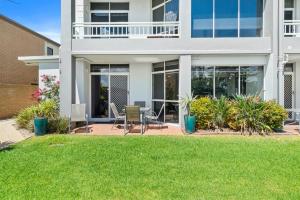 a house with a lawn in front of it at Yarrawonga Lakeside Apartment 49 in Mulwala