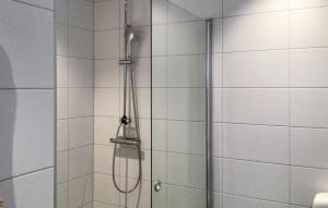 a shower with a shower head in a bathroom at Lovely Home In Blid With Kitchen in Blidö
