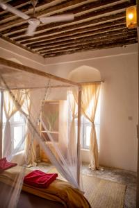 a bedroom with a bed with a mosquito net at Firefly Boutique Lodge in Bagamoyo
