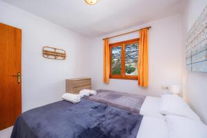 a bedroom with a large bed and a window at Apartamento mhm 5 in Cala Ratjada
