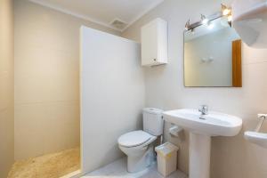 a white bathroom with a toilet and a sink at Apartamento mhm 5 in Cala Ratjada