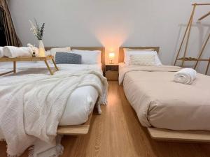 a bedroom with two beds with a table on top at Muji Full Seaview FOC Netflix 2CarPark 3BR 6-12pax in Johor Bahru