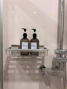 three bottles of soap on a shelf in a bathroom at Muji Full Seaview FOC Netflix 2CarPark 3BR 6-12pax in Johor Bahru