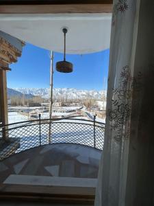a balcony with a view of a snow covered mountain at The Morning Sky hotel in Leh