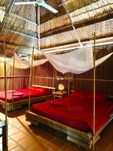 a bedroom with two beds and a hammock at Hometravel Mekong Can Tho in Can Tho