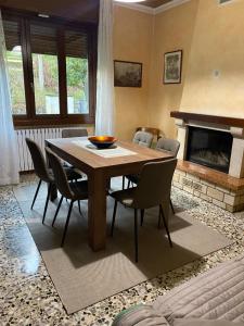 a dining room with a table and chairs and a fireplace at Gere house in Lezzeno