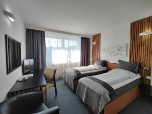Posteľ alebo postele v izbe v ubytovaní Hotel P7