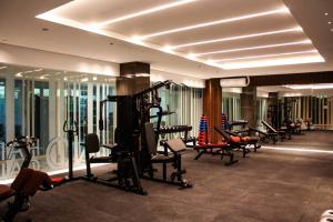 a gym with a bunch of treadmills and machines at Hayat Sky Towers Service Apartment in Cebu City