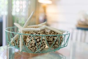 a glass bowl filled with shells and a starfish at Great Northern Beach House in Yorkeys Knob