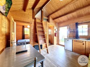a wooden cabin with a ladder in a kitchen at Yucca - Bungalow aux Makes - Saint-Louis in Saint-Louis +15 photos