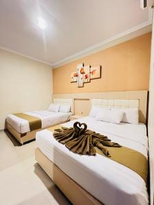 Voodi või voodid majutusasutuse Ayuri Hotel Malioboro toas