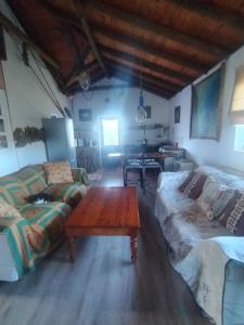 a living room with a couch and a coffee table at Drifters Inn - Cape St Francis in St Francis Bay